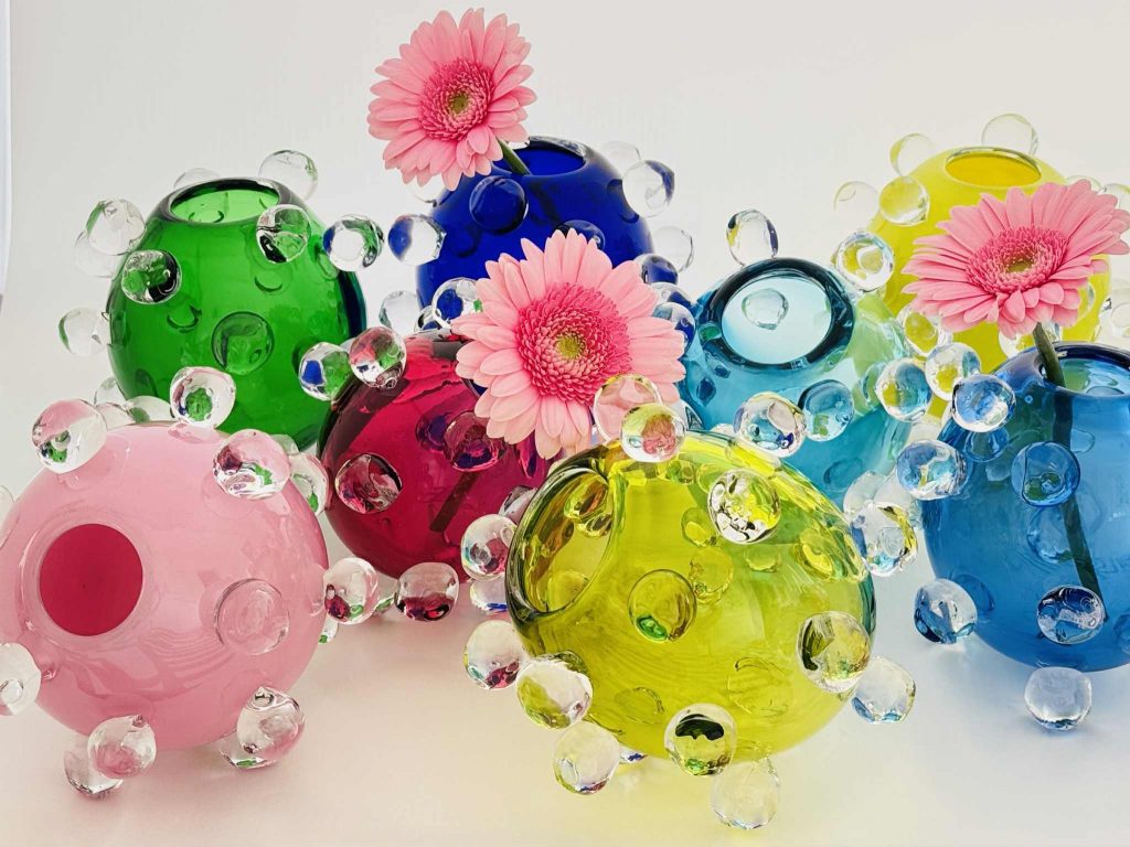 Glasvaser i olika färger med glasbubblor på